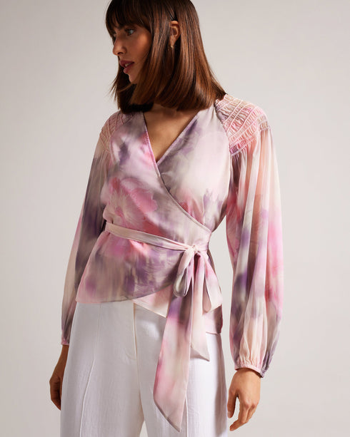 EMILIAH-Tops-Add some spring florals to your wardrobe with our EMILIAH blouse, which features a wrap front and blouson sleeves. Smocked shoulders give the piece extra texture without the bulk.The fabric of this product is made with 100% recycled polyester. Using recycled polyester helps divert plastic waste from ending in landfills, and helps us to reduce our dependence on virgin materials. Blouse Wrap front Blouson sleeves Smocked shoulders Blurred floral print Self tie waist V-neck Julia is 5'10" / 1.78m